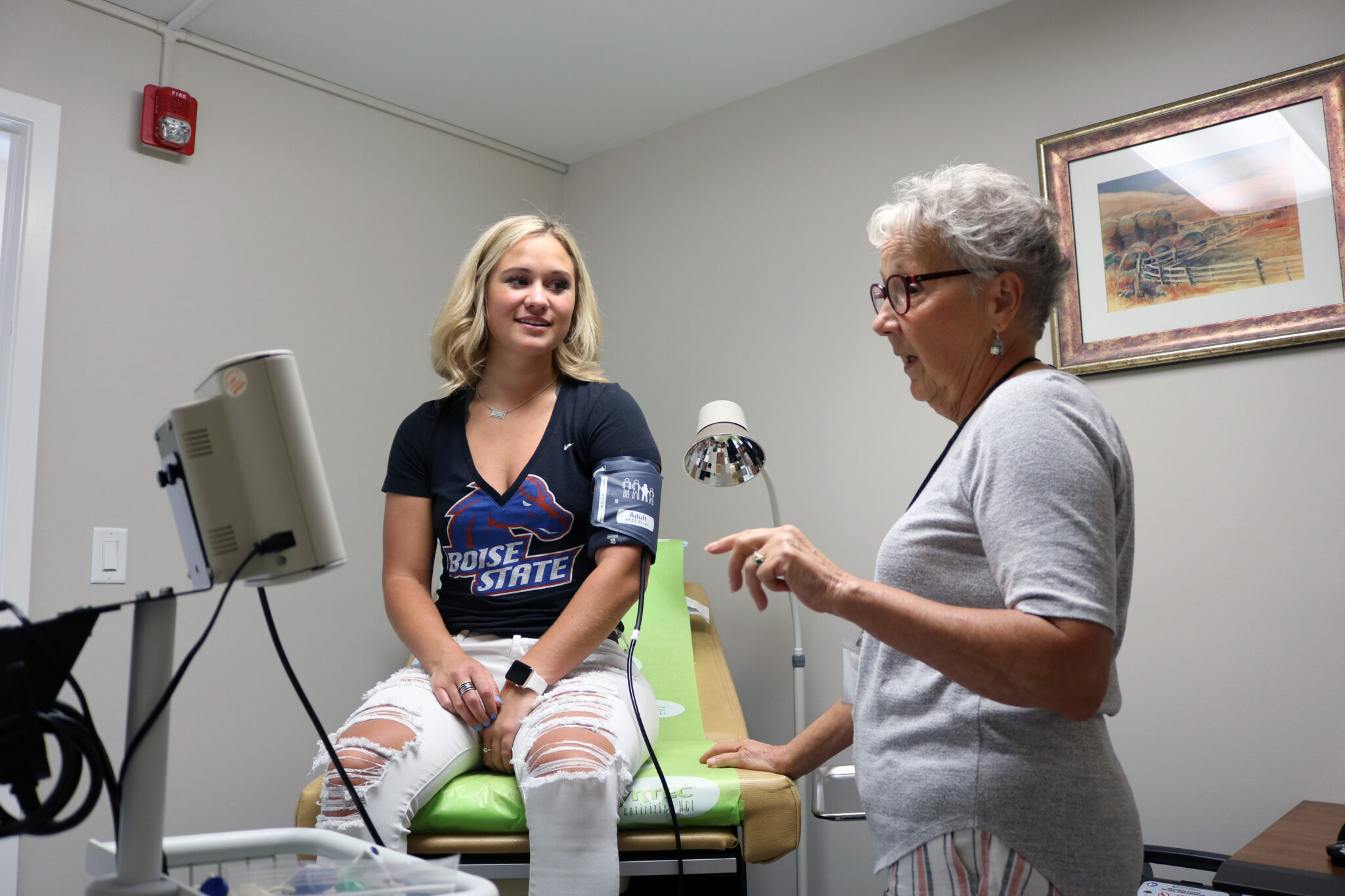 Volunteer nurse checking a patient's blood pressure at the Friendship Clinic