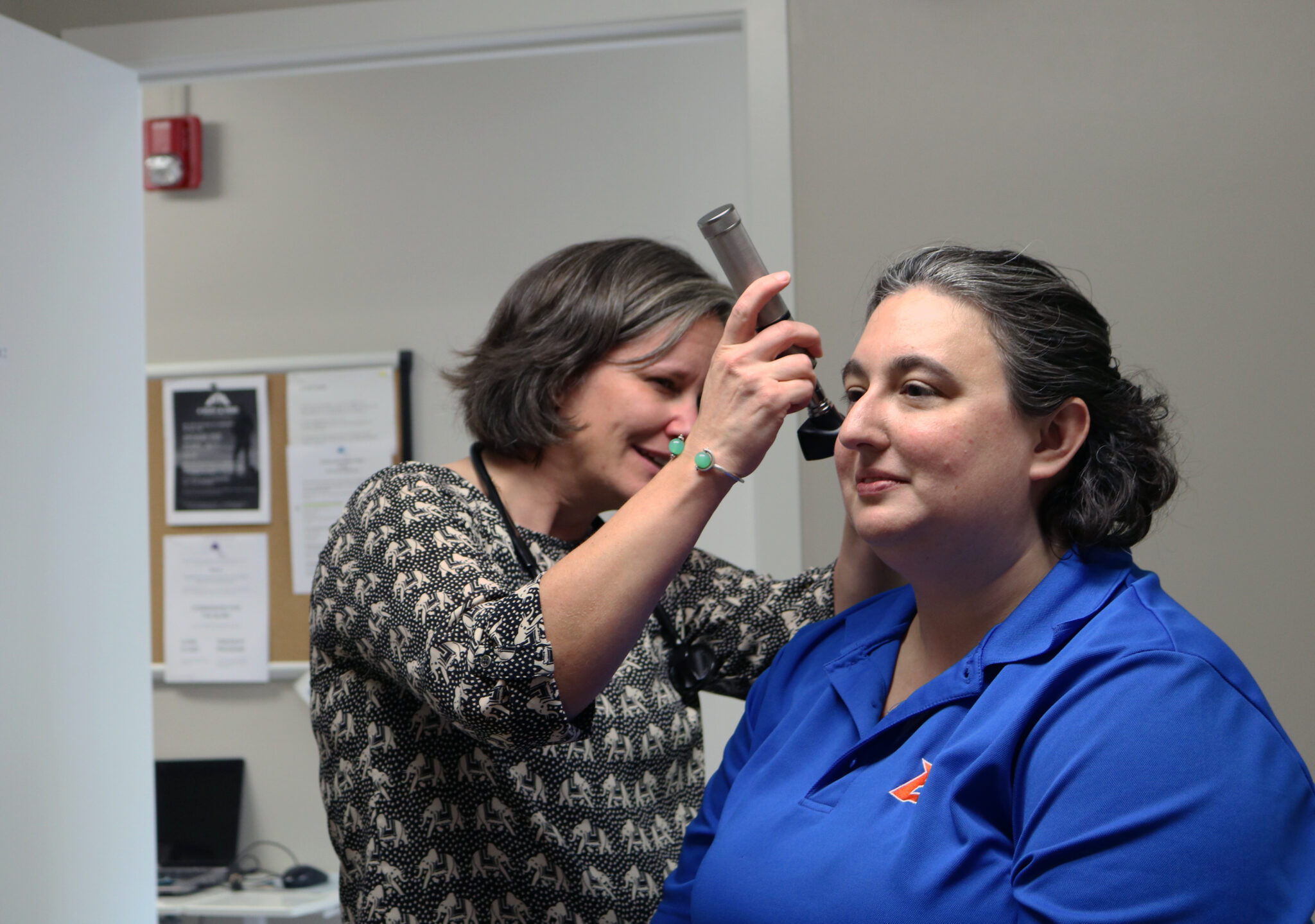 Volunteer provider performing an ear exam at the Friendship Clinic